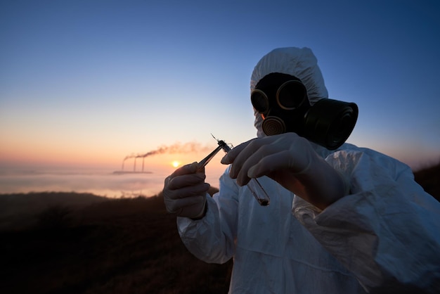 Scientist and smoking stacks of thermal power station