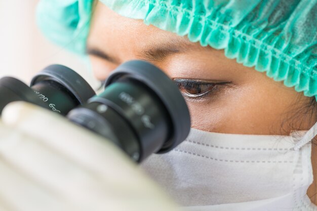 Scientist using a microscope in a laboratory 