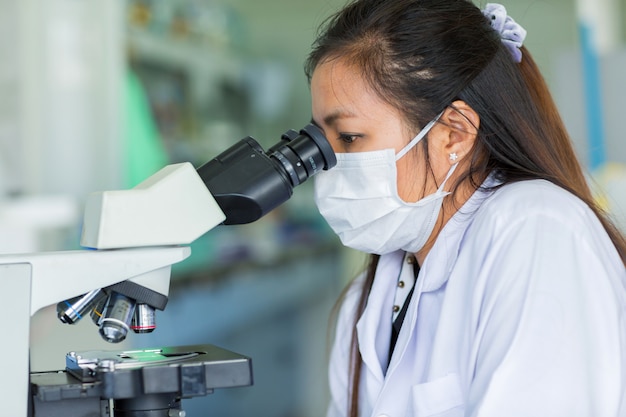 Scientist using a microscope in a laboratory