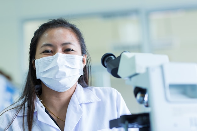 Scientist using a microscope in a laboratory