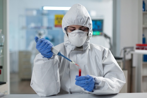 Scientist woman analyzing blood using medical micropippete