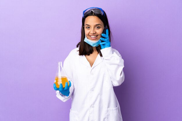 Scientist woman investigating a vaccine to cure coronavirus disease keeping a conversation with the mobile phone with someone