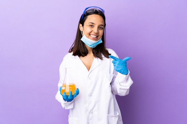 Scientist woman investigating a vaccine to cure disease giving a thumbs up gesture