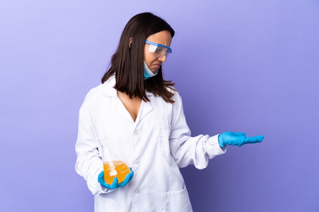 Scientist woman investigating a vaccine to cure disease holding blank space with doubts