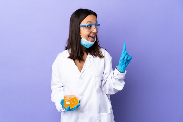 Scientist woman investigating a vaccine  disease intending to realizes the solution while lifting a finger up