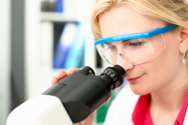 Scientist Woman Looking to Laboratory Microscope