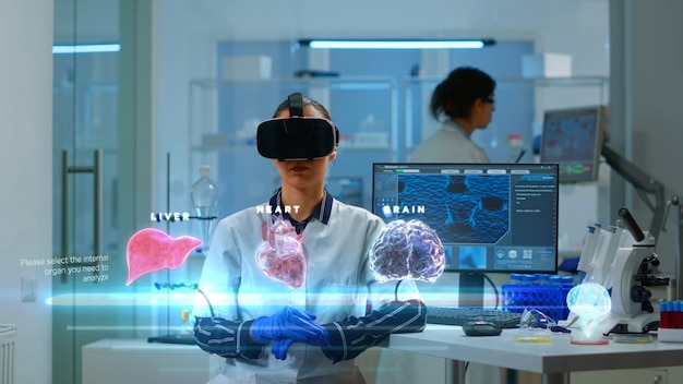 Scientist woman in modern clinic wearing VR headset, using advanced equipment and wired sensors to contribute to neurology research, enhancing understanding of human organs