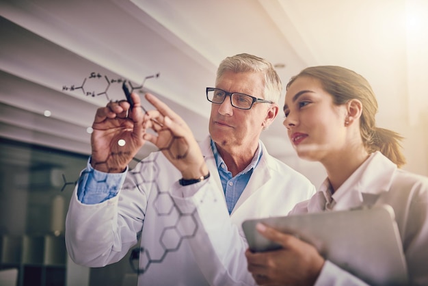 scientists experiment and research with collaboration writing or innovation for notes or discussion in laboratory man woman and glass wall for ideas molecule compound or science formula for drug