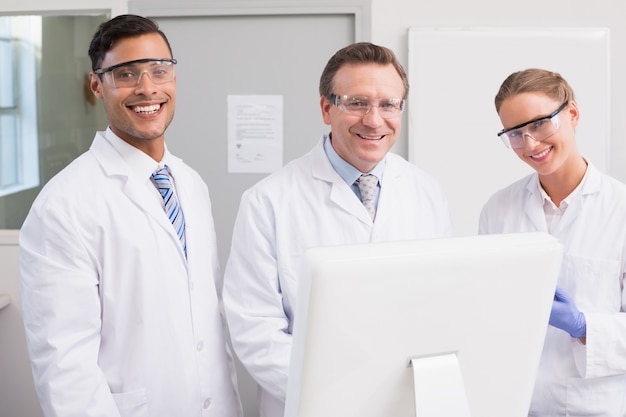 Scientists smiling and looking at camera