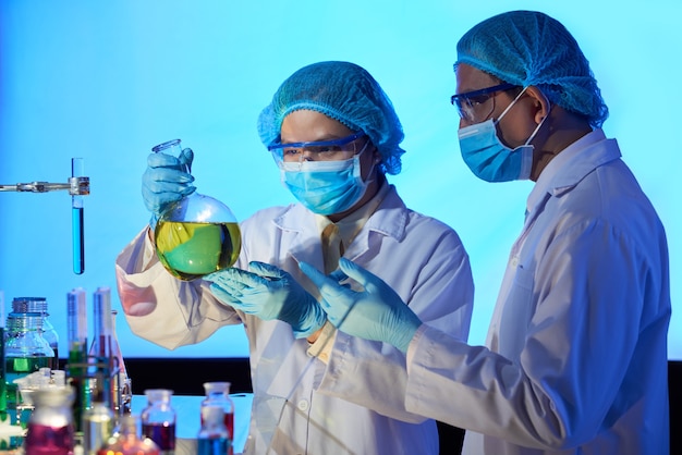 Scientists with big flask