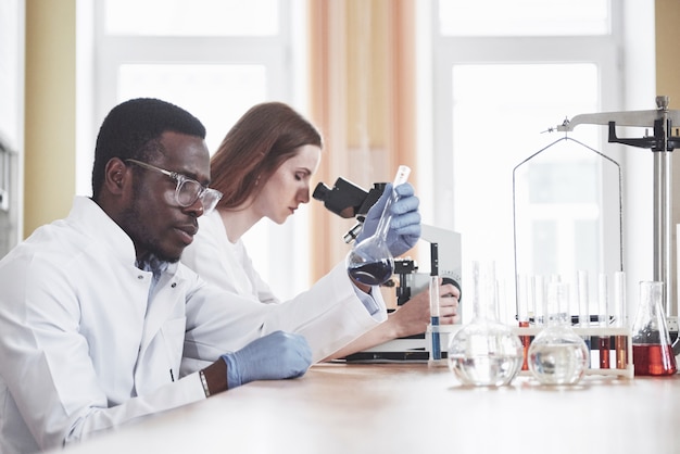 scientists work closely with the microscope in the laboratory by conducting experiments and analyzes.