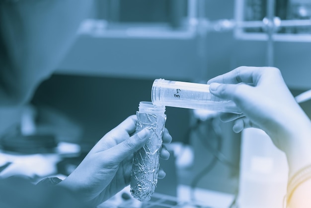 Scientists working in the laboratoryDoing an experimentMix chemical with tube