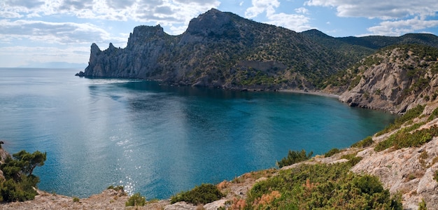 Scintillate sea surface and summer rocky coastline  ("Novyj Svit" reserve, "Rhinoceros" cape, Crimea, Ukraine). Two shots stitch image.