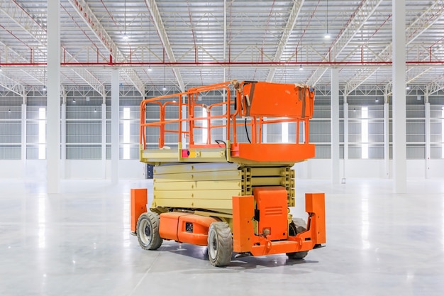 Scissor lift aerial work platform at a construction site.