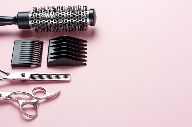 Scissors and comb on pink