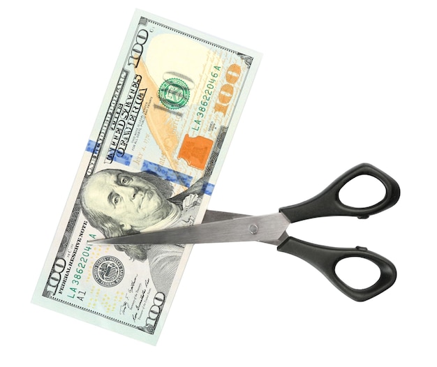 Photo scissors cut dollar banknote isolated on white