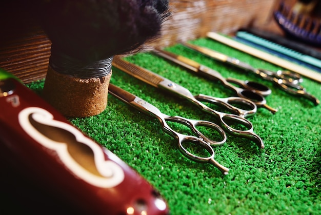 Scissors for cutting on a green mat in barbershop