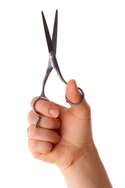 Scissors in the hand isolated on white