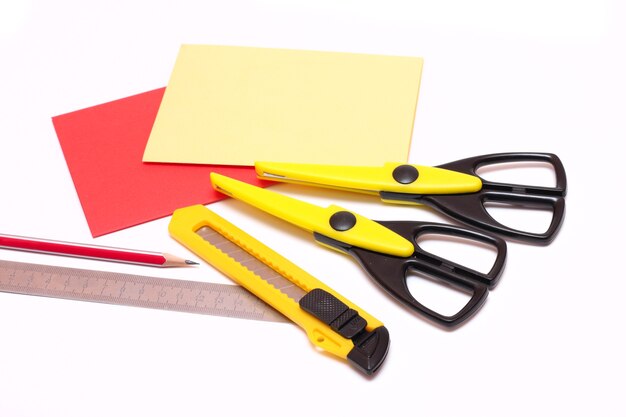 Photo scissors ruler and penci with paper on a white background close-up