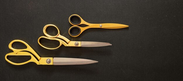 Photo scissors set gold on black background top view