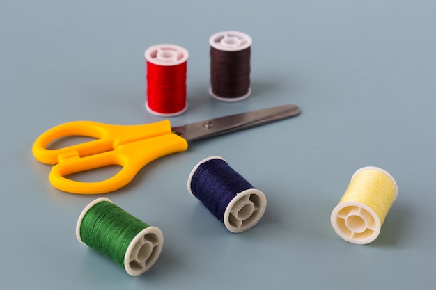 Scissors, spools of colored thread.