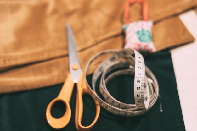 Photo scissors tape measure coni with pins on cloth