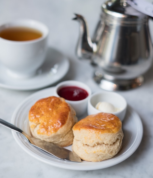 Scone set with strawberry jam, cream cheese and hot tea