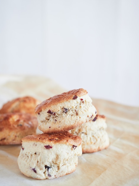 Scons with dried cranberry pieces on baking paper.