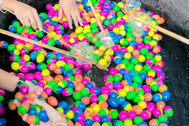 Scoop the egg ball in the water game In plastic eggs besides just filling number of gift
