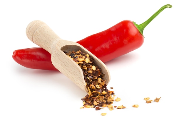 Scoop of ground chili and chili pepper