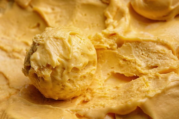 A scoop of mango ice cream closeup