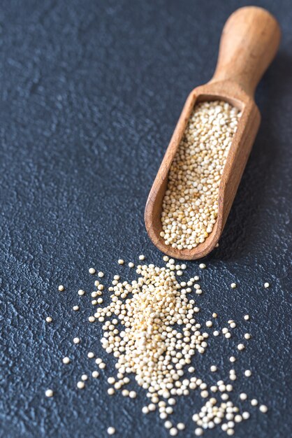 Scoop of raw quinoa