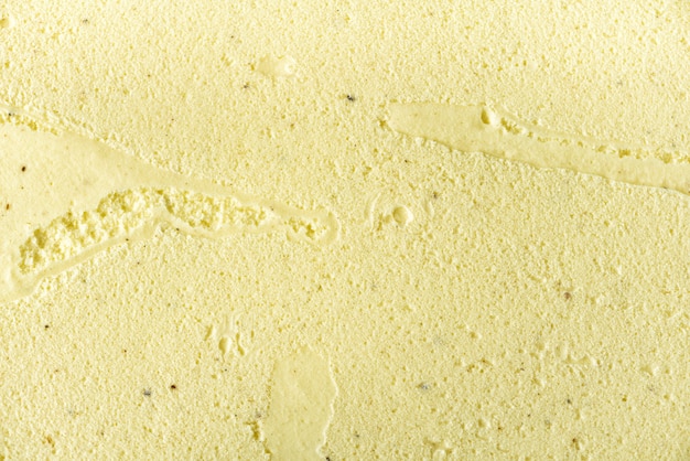 Scooped vanilla ice cream . Summer food concept, copy space, top view. Sweet yogurt dessert or yellow ice-cream texture.