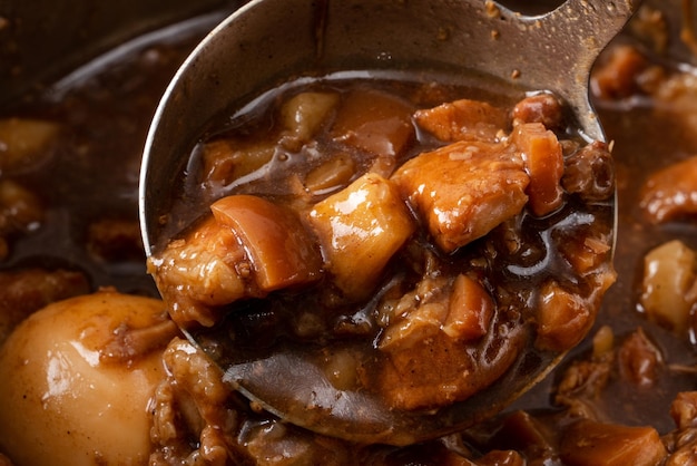 Scooping stewed and braised minced pork for almost eating with white cooked rice. Taiwanese traditional cuisine food.