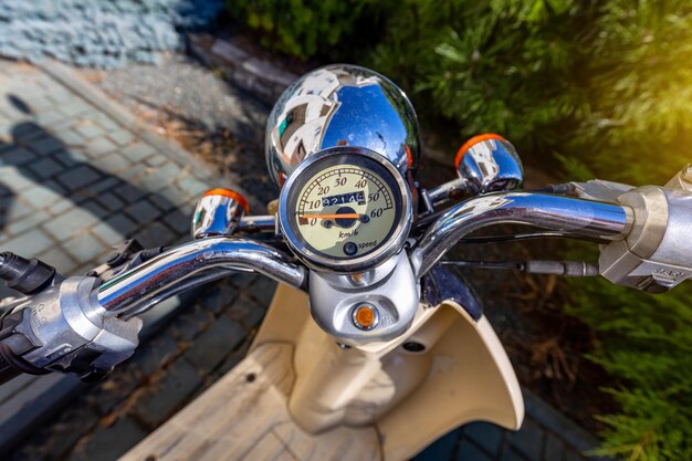 A scooter and its speedometer under the open sky Travel on a scooter in Italy