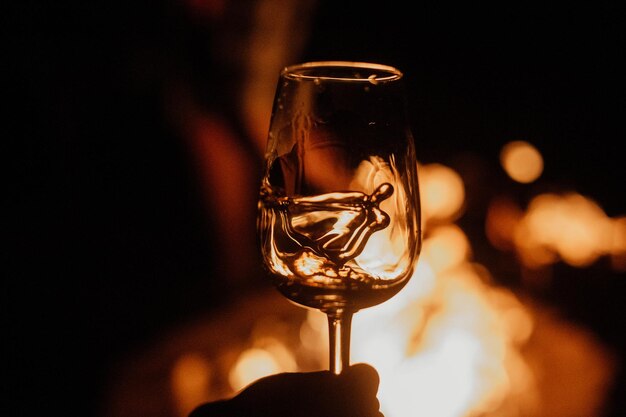 Scotch in glass glowing with fireplace