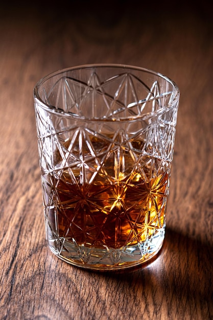 Scotch whiskey glass on wooden table