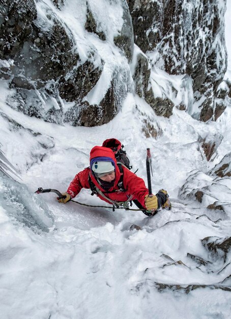 Scotland, Anoach Mor, Man ice climbing in winter