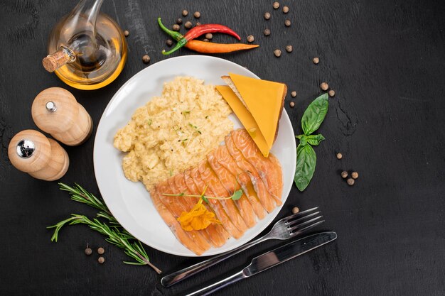 Scramble egg with salmon and cheese sandwich on wooden background