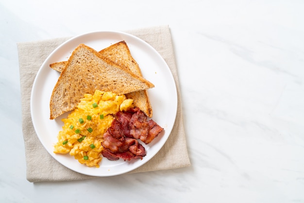 Uova strapazzate con pane tostato e pancetta per colazione