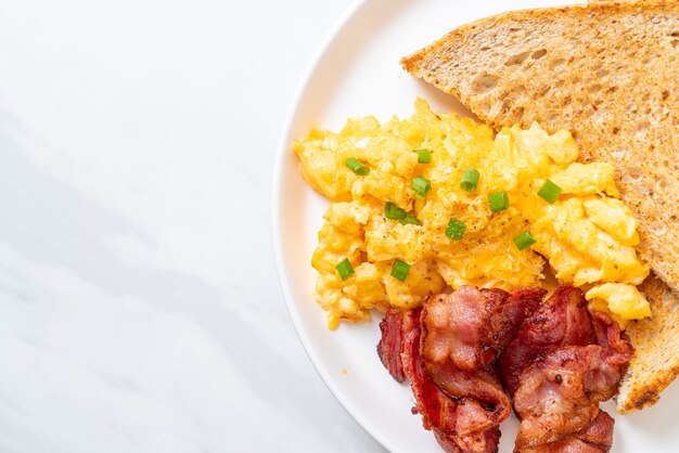 scrambled egg with toasted bread and bacon