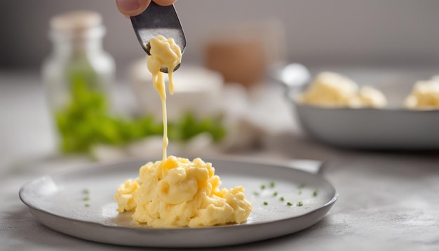 Photo scrambled eggs in the form of a heart on a metal spatula on a blurry background