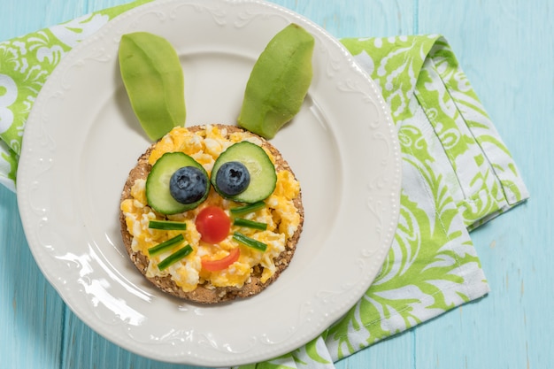 Scrambled eggs funny bunny for kid breakfast