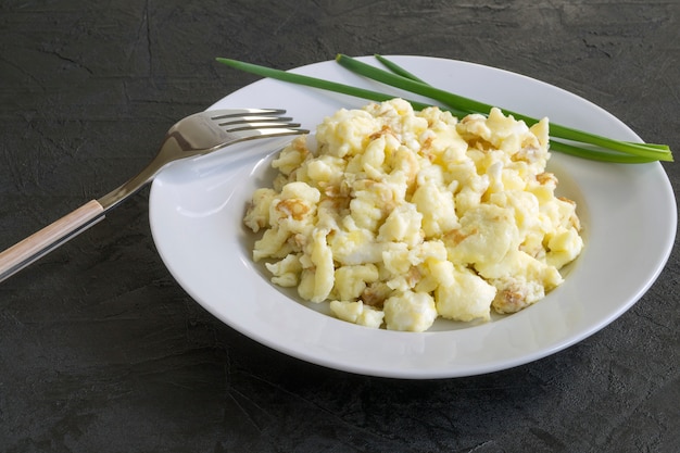 scrambled eggs on a white plate.