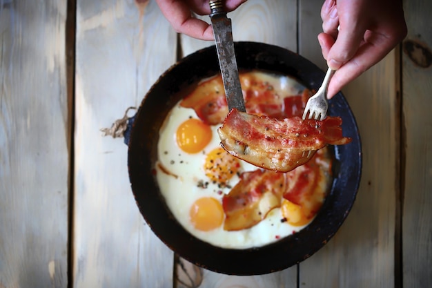 Scrambled eggs with bacon in a skillet