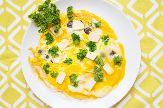 Scrambled eggs with fresh herbs on a plate