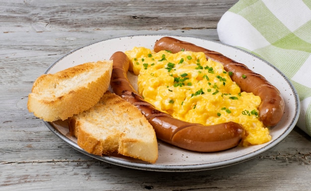 Scrambled eggs with sausages served on a plate