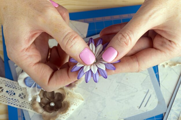 Scrapbook background. Hands, Card and tools with decoration