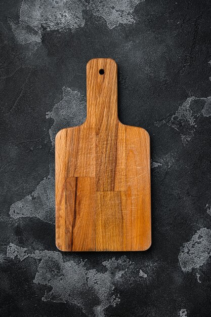 Scratched chopping board set, on black dark stone table background, top view flat lay , with copy space for text or your product