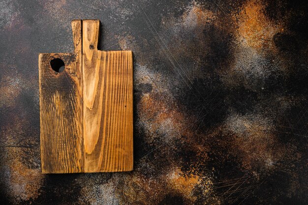 Scratched chopping board set, top view flat lay , with copy space for text or food, on old dark rustic table background